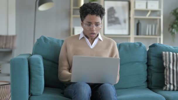 Praca młody African dziewczyna siedzący na kanapie i coraz podkreślił — Wideo stockowe