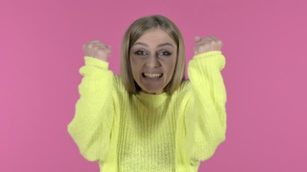 Excited Young Girl Celebrating Success with Fist, Pink Background — Stock Video