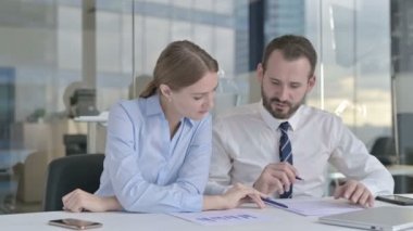 Executive Business people Discussing the Documents on Office Desk