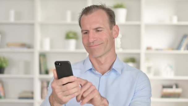 Portrait of Focused Middle Aged Businessman using Smartphone — Stock Video