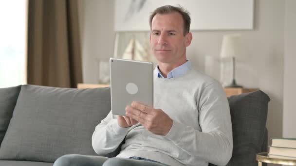 Middle Aged Businessman Celebrating Success on Tablet at Home — Stock Video