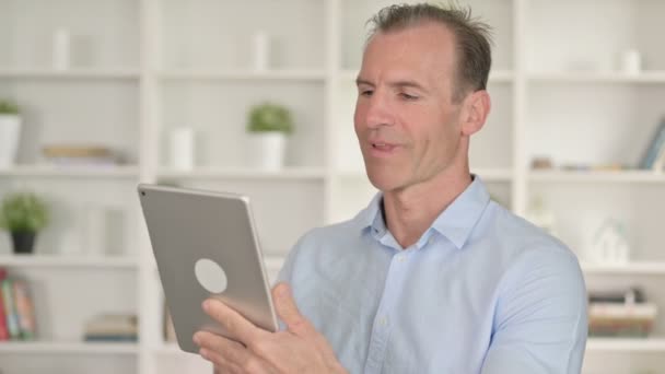 Portrait of Middle Aged Businessman doing Video Chat on Tablet — Stockvideo