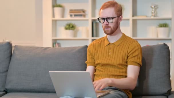 Tvrdě pracující zrzavý muž s bolestí zápěstí pracující na notebooku — Stock video