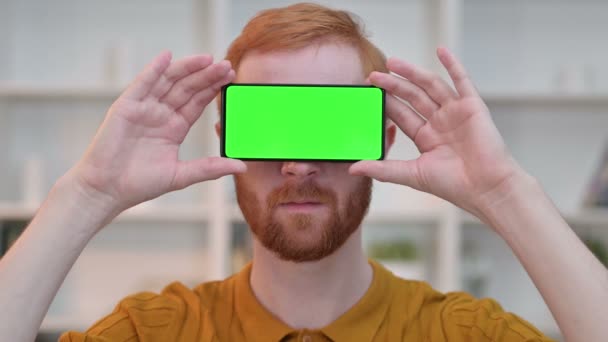 Portrait of Redhead Man having Smartphone with Chroma Screen over Eyes — Stock Video