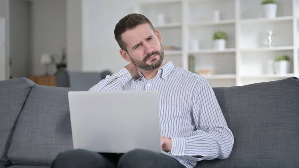 Hardworking Young Man with Laptop having Neck Pain at Home — Stock Photo, Image