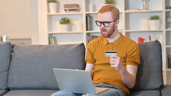 Unsuccessful Online Payment by Redhead Man on Laptop