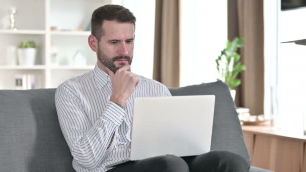 Pensive Young Businessman thinking and working on Laptop at Home — 비디오