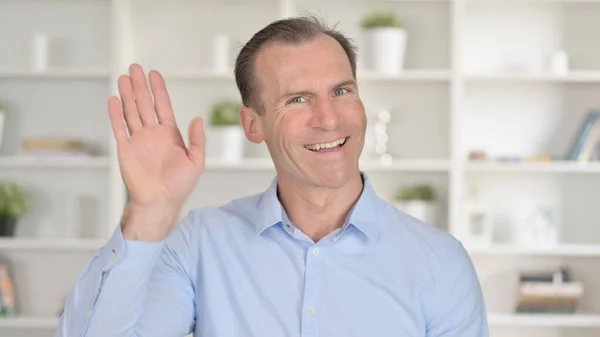 Portrait of Middle Aged Businessman doing Video Chat and Waving — Stock Photo, Image