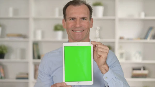 Smiling Middle Age Businessman holding Tablet with Chroma Key Screen — Stock Photo, Image