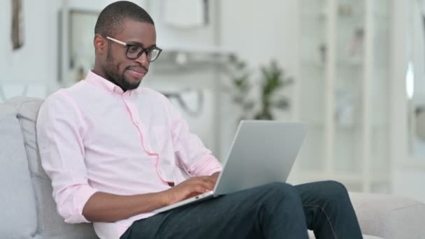 Thumbs Up by African Man with Laptop at Home – stockvideo