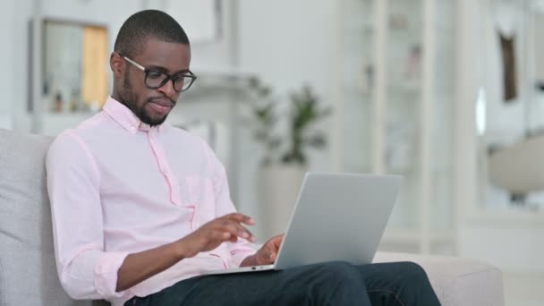 Vincere, l'uomo africano festeggia il successo sul computer portatile a casa — Video Stock