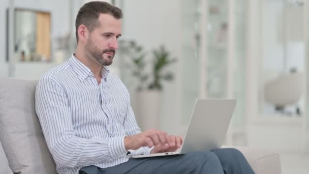 Jovem fazendo chamada de vídeo no laptop em casa — Vídeo de Stock