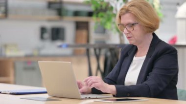 Dizüstü bilgisayarlı Ciddi İş Kadını Kameraya Bakıyor