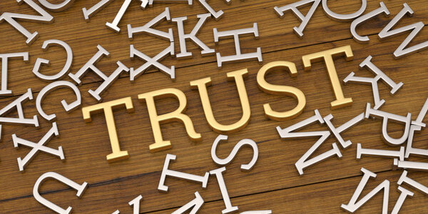 Golden trust text and steel alphabet on wooden board 3D illustration.