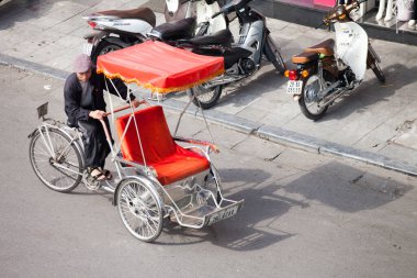 Hanoi caddesinde bisiklet sürücüsü konik şapka takıyor