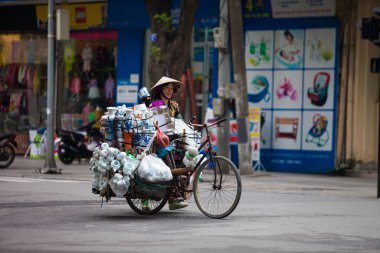 Hanoi, Vietnam - 21 Kasım 2019: Sokak satıcıları Hanoi, Vietnam 'da küçük bir mahallede müşteri bulmak için acele bir şekilde caddenin karşısına geçiyorlar