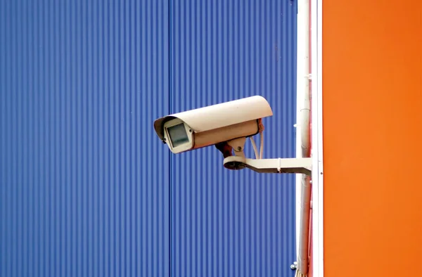 Camera surveillance on the wall of the building. Big brother watches and spies to you.