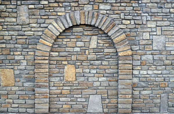 Walled-up archway in a stone wall — Stock Photo, Image