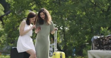 Smarthone kullanarak bagaj ile iki kadın