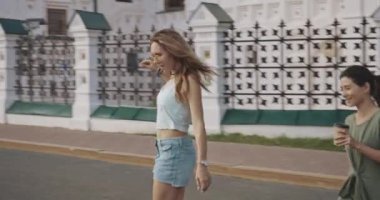 İki kaykaycı kız gün batımında birlikte eğleniyor