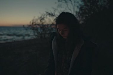 Bir kız şenlik ateşi üzerinde eller ısınma