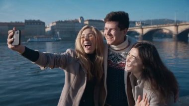 Prag 'da kendini alan üç arkadaş. Seyahat, arkadaşlık, gençlik, milenyum, blog yazarı, şöhret sosyal medya kavramı. Çekimler kırmızı 4k, 10 bit renk