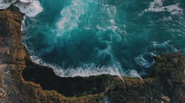 Gök mavisi gelgitlerin ve yükselen deniz köpüğünün inanılmaz arka planı. Doğal güçlerin nefes kesici manzarası ve dokunulmamış güzellik. Tropikal kayalık adaların ve dalgaların hareketli görüntüsü. Seyahat kavramı.