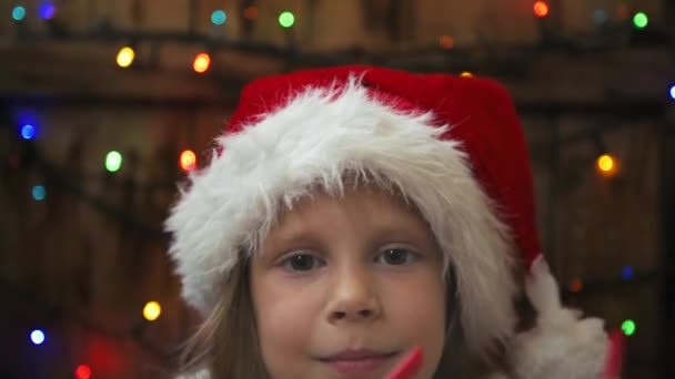 Cute Happy Girl Wearing Christmas Hat Putting Optical Glasses — Stock Video