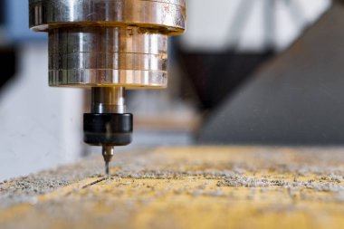 Turning and milling machine with CNC. Closeup of a spindle with a cutter during milling of the workpiece. clipart