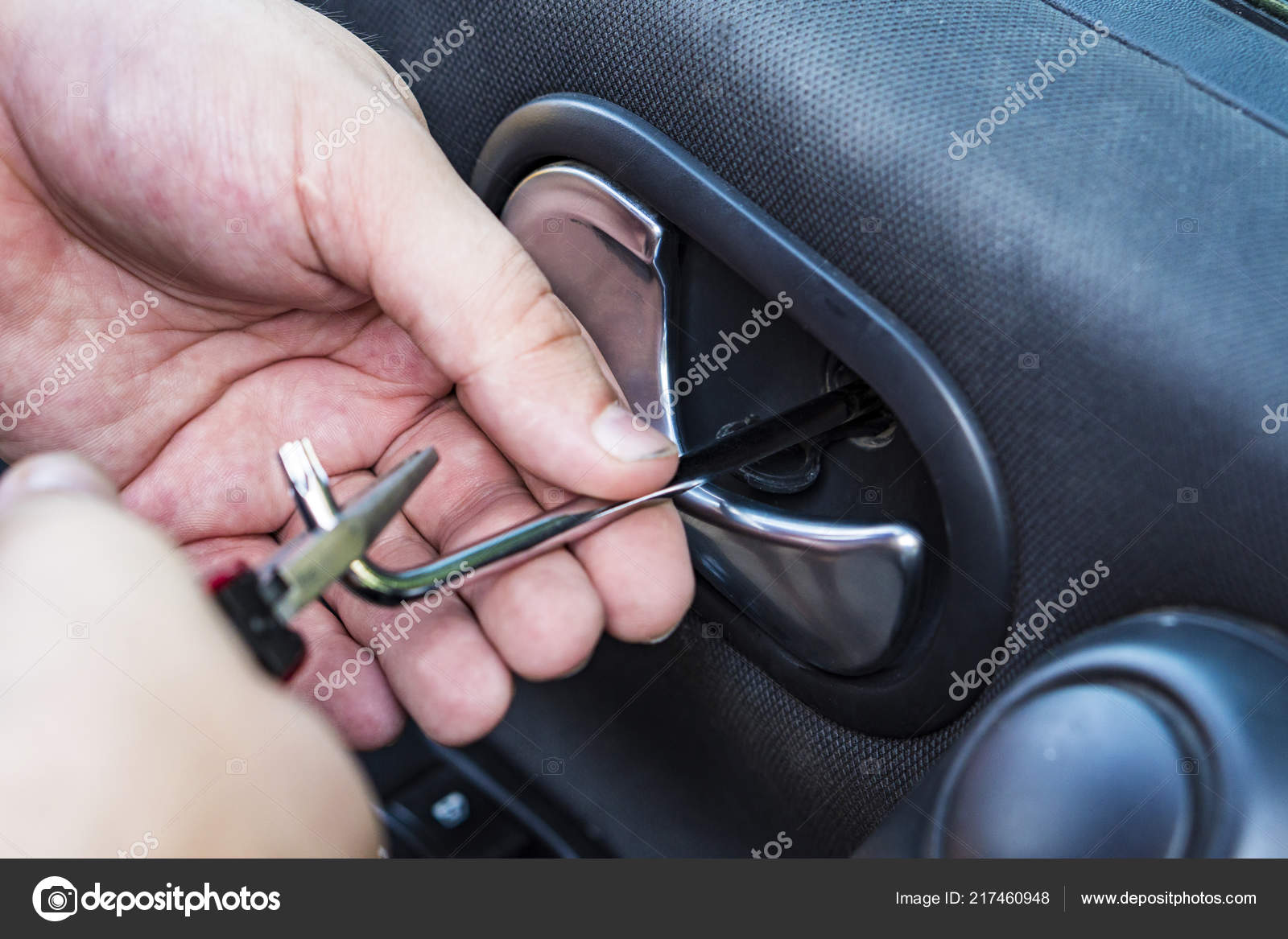 Car door handle repair. Allen key in mechanics hand. Stock Photo by