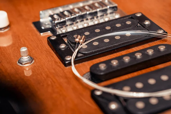 Electric guitar. Pickup and guitar string. Close-up.