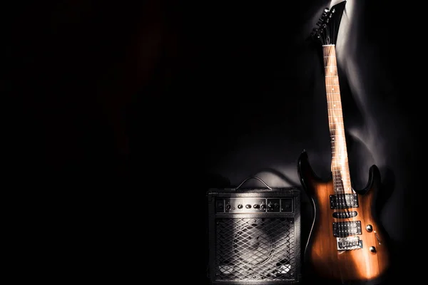 Guitarra eléctrica y amplificador sobre fondo oscuro. Efecto luz —  Fotos de Stock