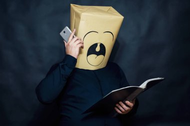 Duygu kavramı. Bir adam bir kitap okuyor. Cep telefonu mesajı dinle. Esnemek.