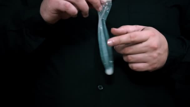 Safe sex concept. used Condom in man hand — Stock Video