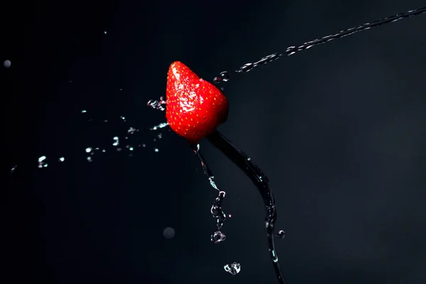 Strawberry on a fork. Freeze motion splash water — Stock Photo, Image