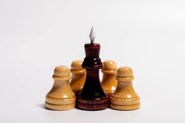 Black king in the center with chess pieces of pawns.