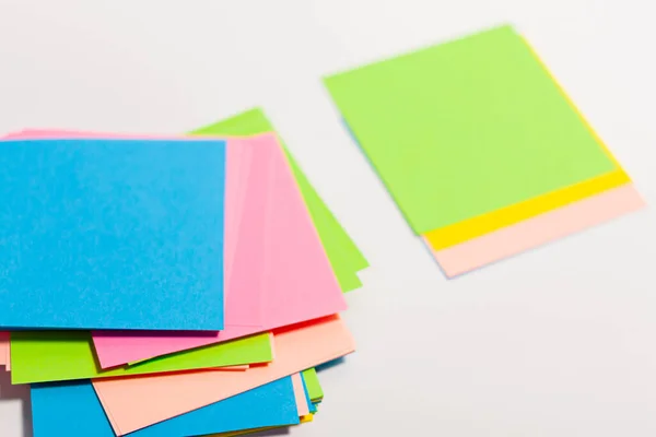 Sheets of paper of different colors on a white surface. — Stock Photo, Image