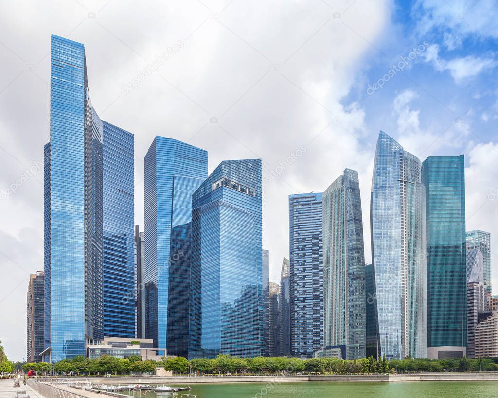 Glass high skyscrapers in the center of Singapore on the waterfront. Skyline financial center of the city, new modern office buildings.