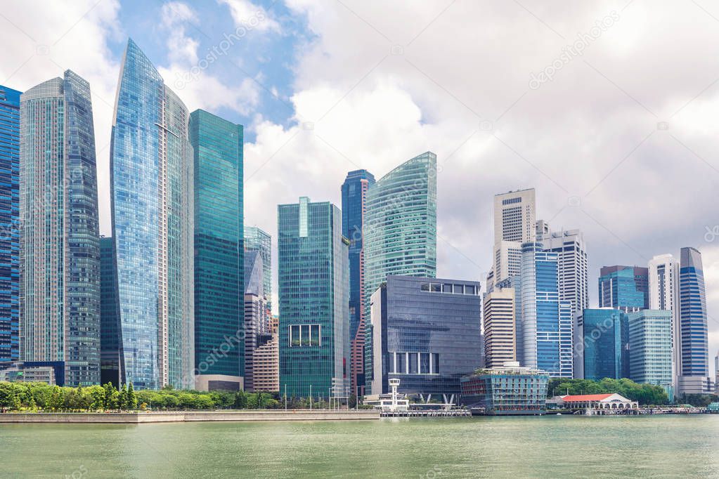 Glass high skyscrapers in the center of Singapore on the waterfront. Skyline financial center of the city, new modern office buildings on embankment