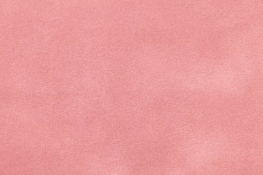 Süet kumaştan açık pembe bir arka plan, yakın plan. Pürüzsüz pastel derinin kadife dokusu..