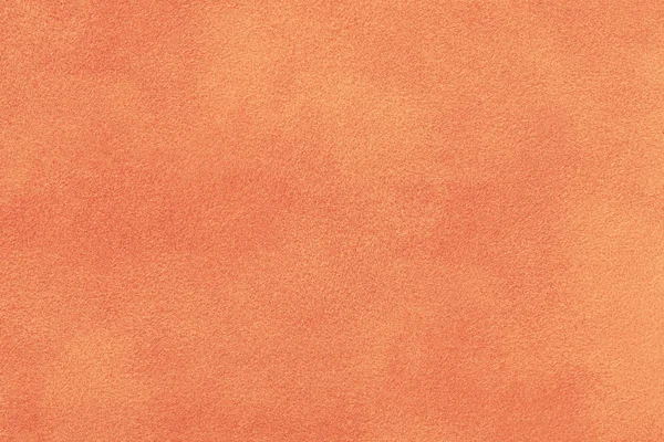 Light orange matte background of suede fabric, closeup. Velvet texture of  seamless ginger woolen felt Stock Photo