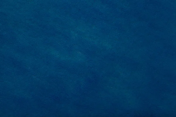 フェルト生地 クローズ アップの光スポットとネイビー ブルーの背景の建設 ウールのマット デニム織物の質感 布の背景 — ストック写真