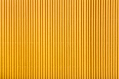 Doku oluklu sarı kağıt, makro. Altın karton arka plan, closeup çizgili desen.