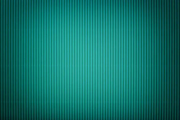 Texture of corrugated dark turquoise paper with vignette, macro. Striped pattern of cyan cardboard background, closeup.