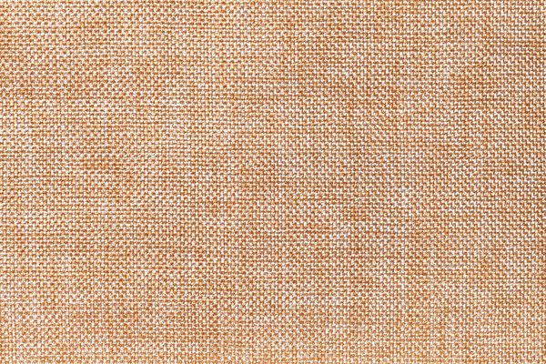 Light orange and white background of dense woven bagging fabric, closeup. Structure of the brown cloth with natural texture. Cloth backdrop.
