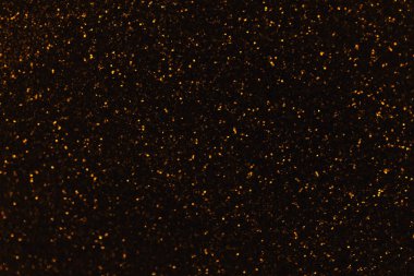 Altın arka plan bulanık circle parlak ışıklar ile. Parlak siyah ışıltılı bokeh Noel Garland. Koyu zemin