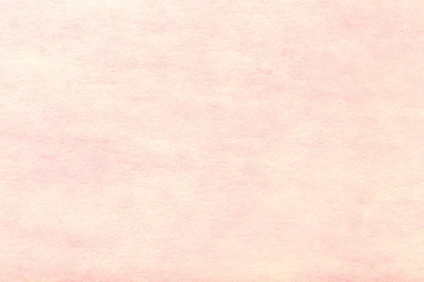 Light pink matte background of suede fabric, closeup. Velvet texture of seamless rose woolen felt. Pastel color.