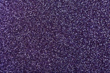 Küçük payetler, çekim koyu mor köpüklü arka plan. Parlak zemin.