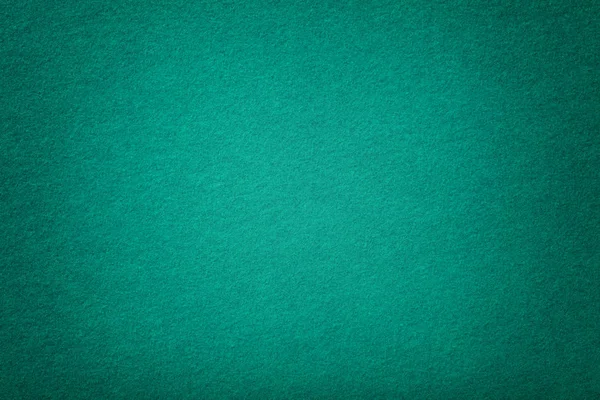 Dark turquoise matt suede fabric closeup. Velvet texture of felt.