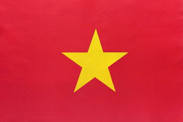 Vietnam nationale stof vlag met embleem, textiel achtergrond. — Stockfoto